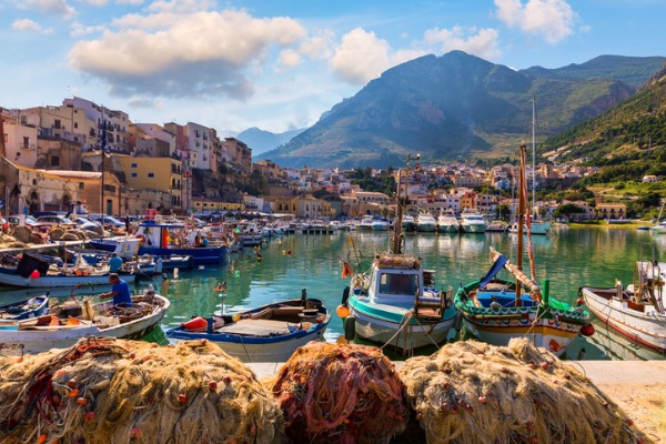 נמל בטרפני באי סיציליה שבאיטליה, סירות בנמל, בתים והרים ירוקים ברקע